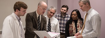 Dr. Scott Stringer explains notes to a student group.jpg